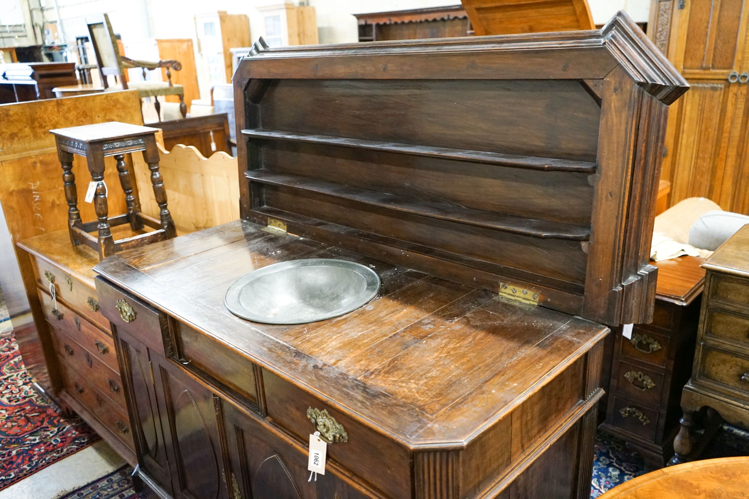 A 19th century Dutch mahogany sideboard, length 136cm, depth 56cm, height 104cm with raised shelved back over two frieze drawers and a pair of 'Gothic'-panelled cupboard doors, the top inset a pewter bowl